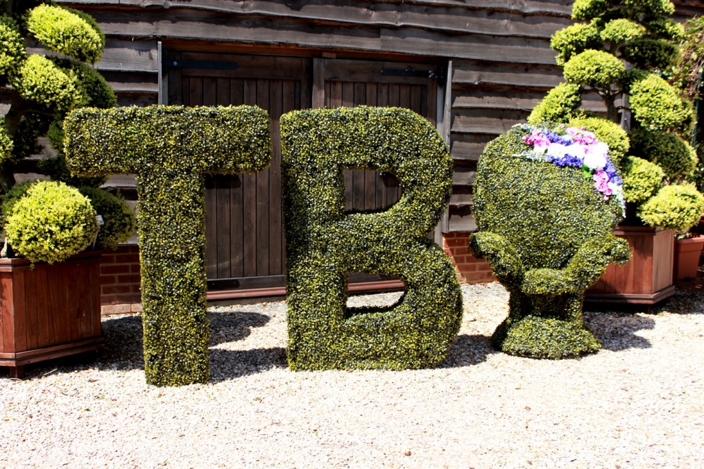 Artificial Topiary version of 'T' & 'B' with an artificial topiary chair.